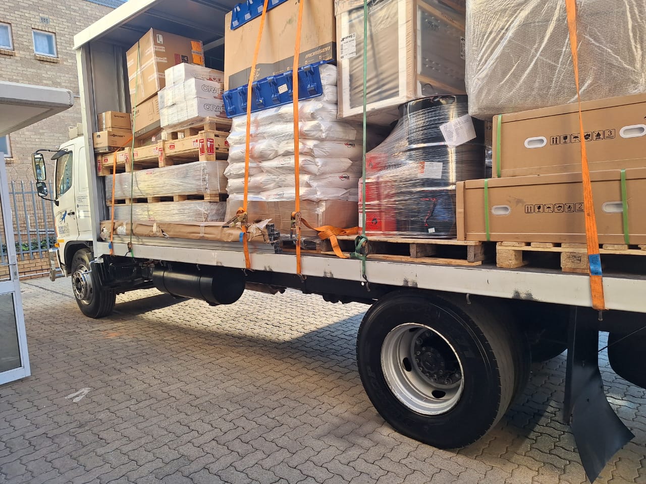 Consolidated shipment of mixed client cargo strapped on a Springboard truck