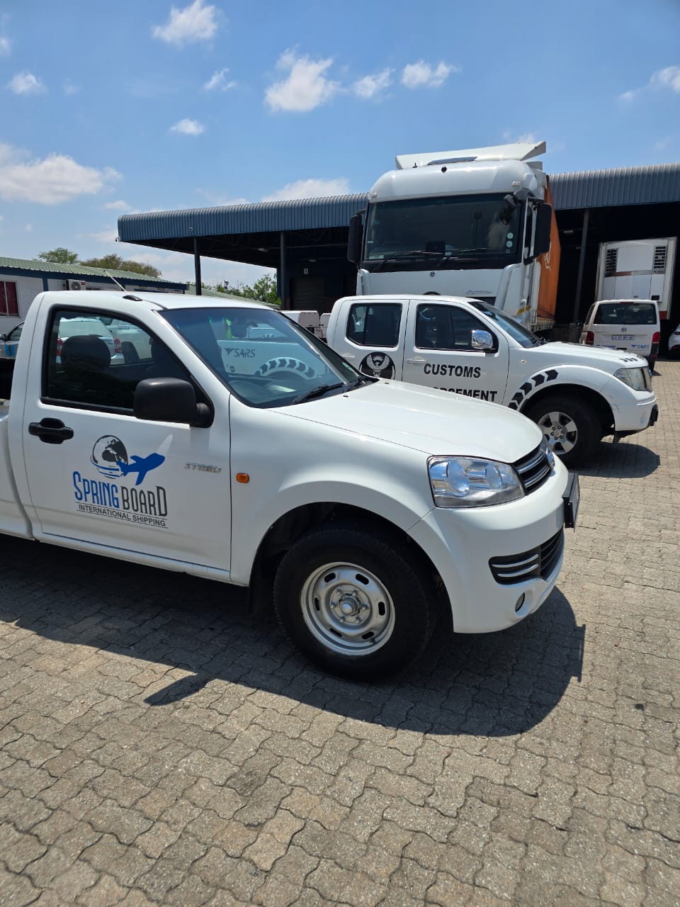 Springboard vehicle alongside a customs enforcement vehicle